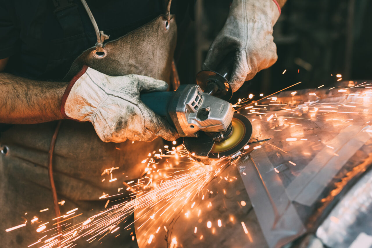 hands-of-metalworker-grinding-copper-in-forge-work-2022-03-07-23-55-48-utc-1280x854.jpg